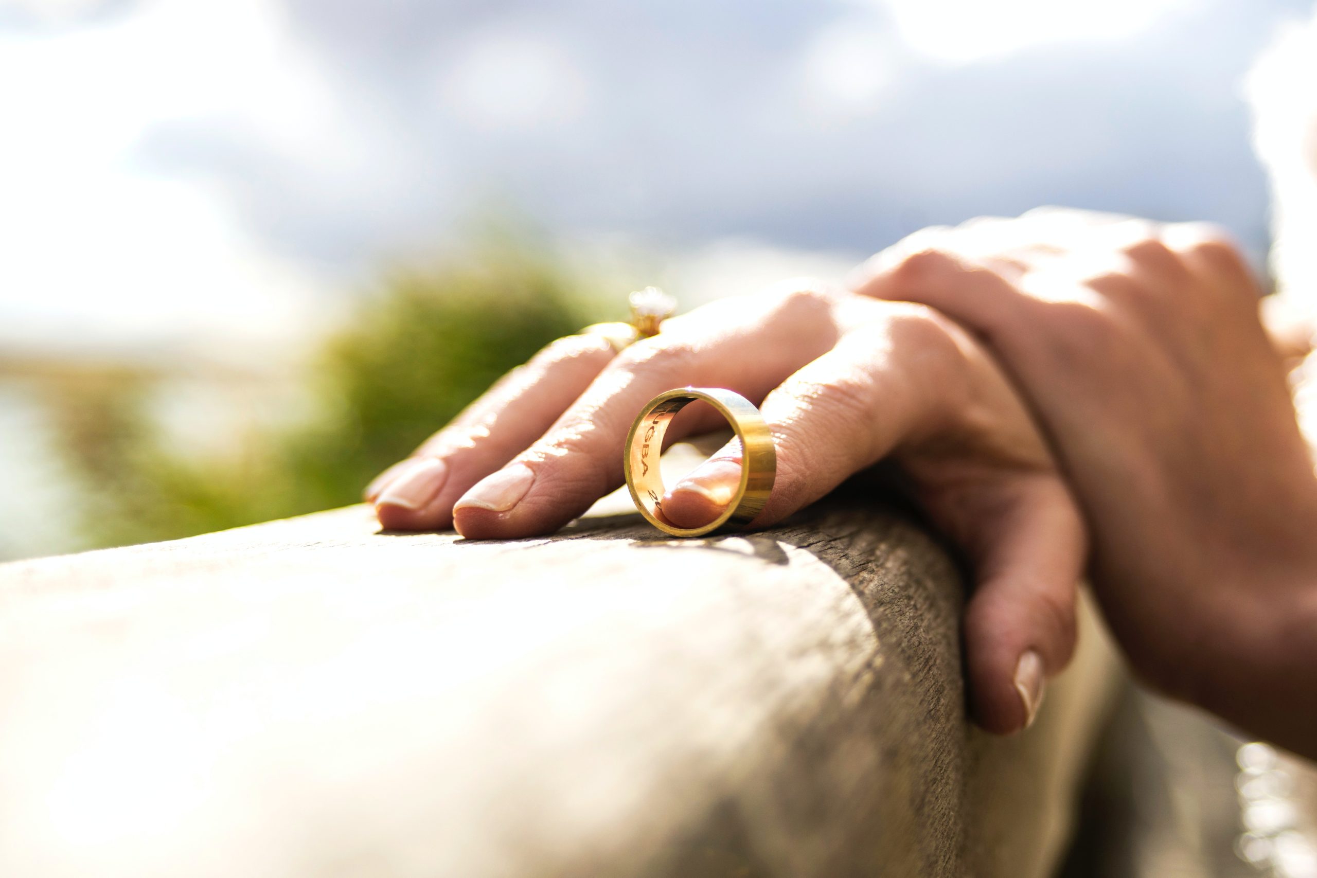 Woman holding her wedding ring and contemplating reasons for divorce in Wisconsin