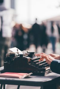 A woman using typewriter as it is best time to begin estate planning in Wisconsin